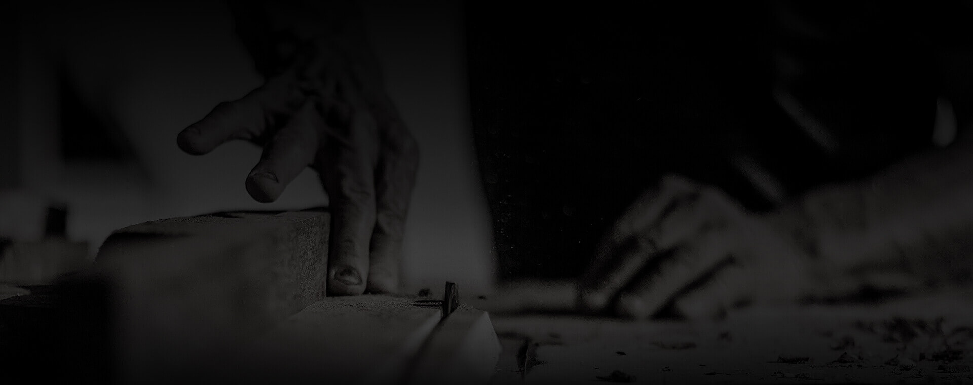 Carpenter’s hands working on a piece of wood