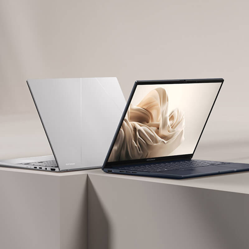 A ponder blue and a foggy silver Zenbook 14 OLED appear back-to-back on a stylized beige and white background.