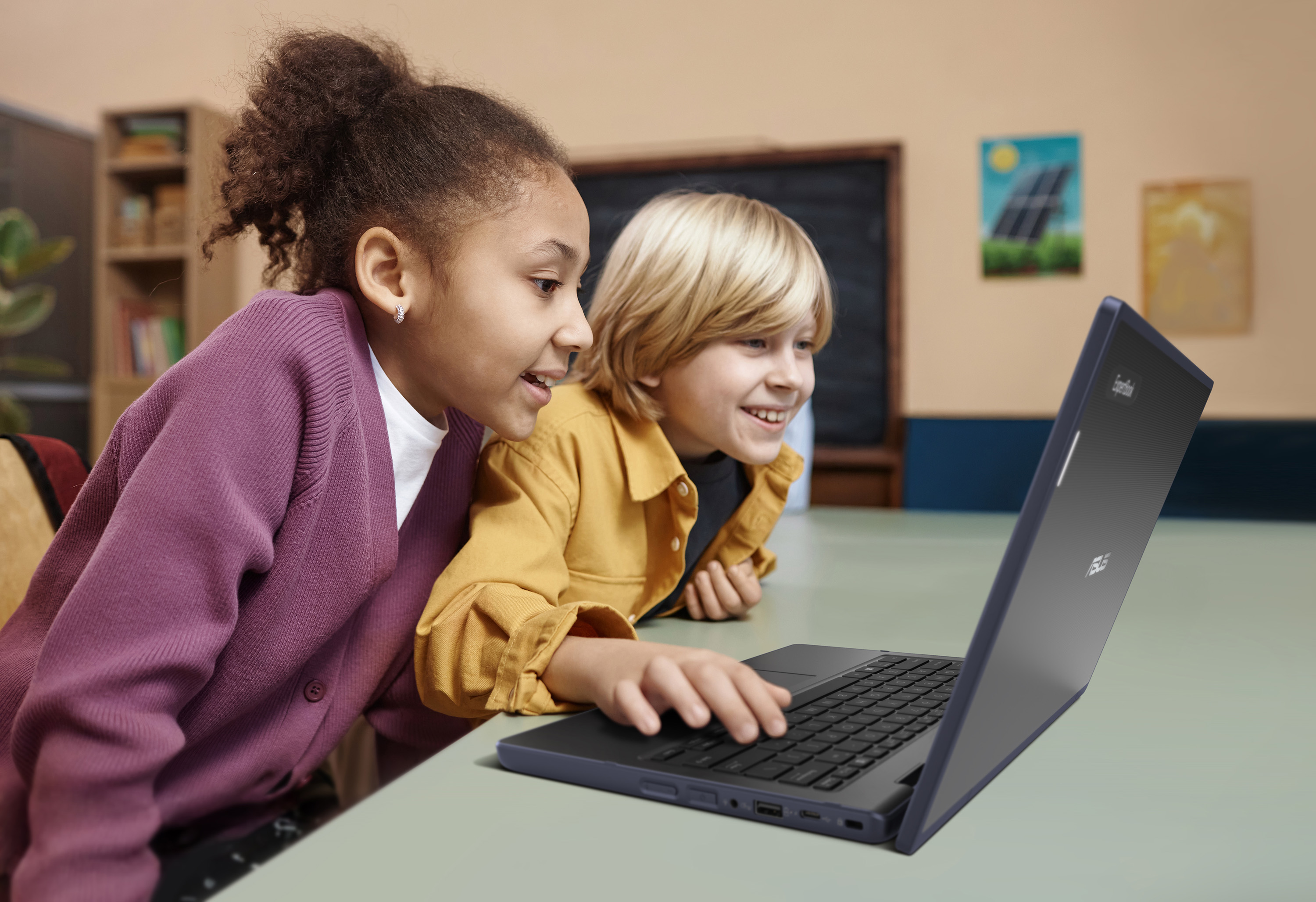 Two young students using an ASUS BR series laptops in a classroom