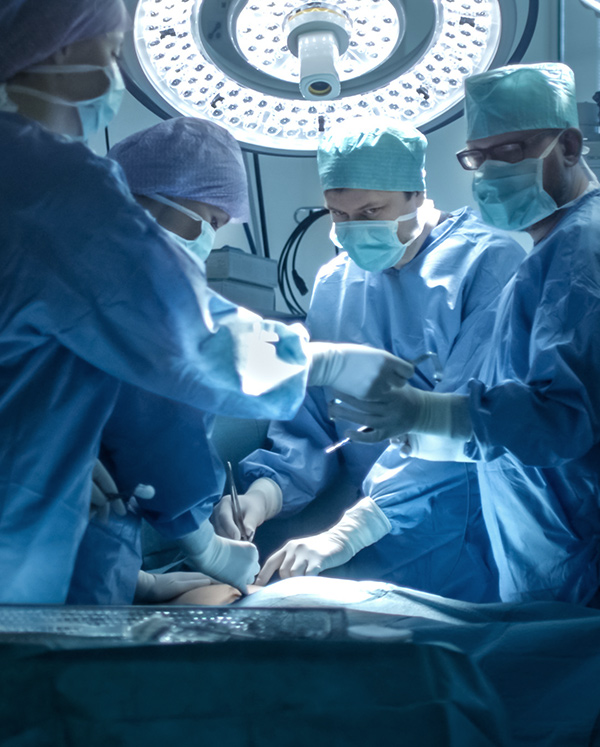 A group of doctors is in operation room performing surgery