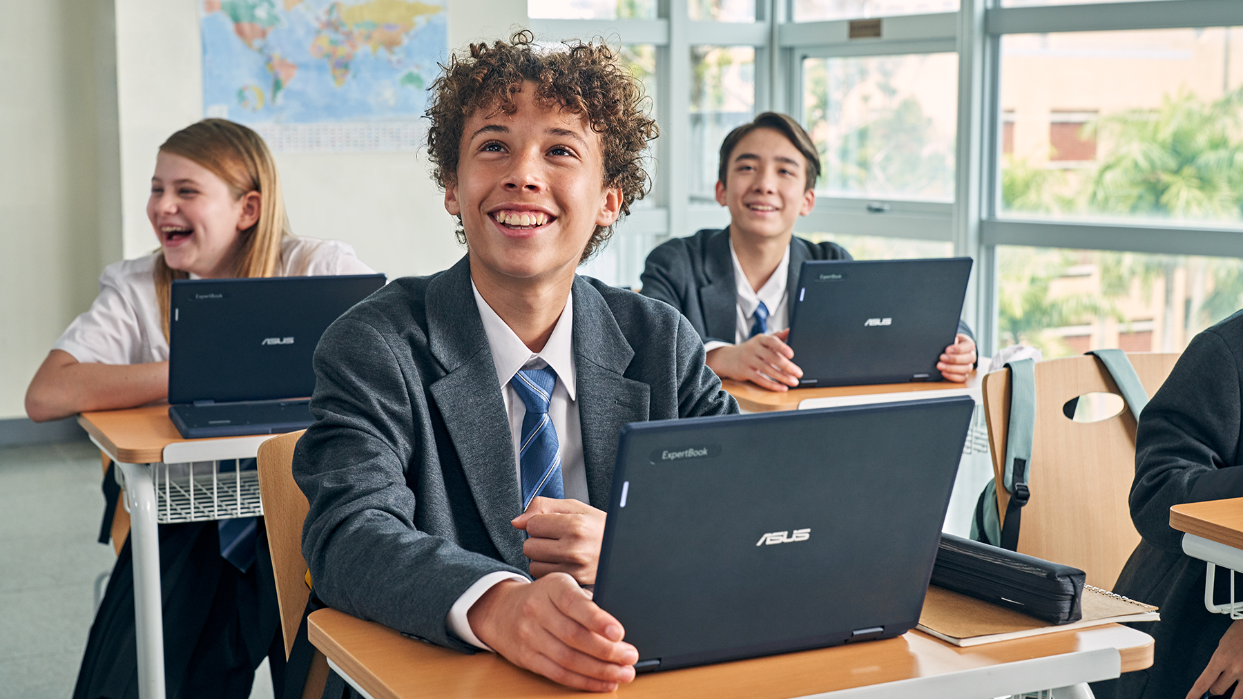 Students using ASUS BR series laptops in a classroom