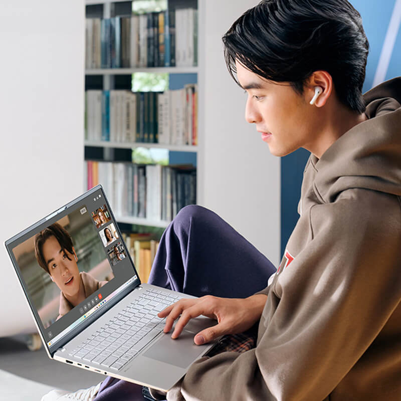 A young man uses ASUS Vivobook S 15 laptop for videoconferencing.