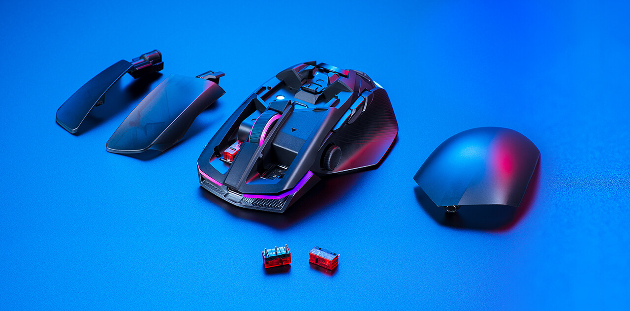 An image of showing the magnetic covers and switches removed from the mouse. The removed components are set to the side