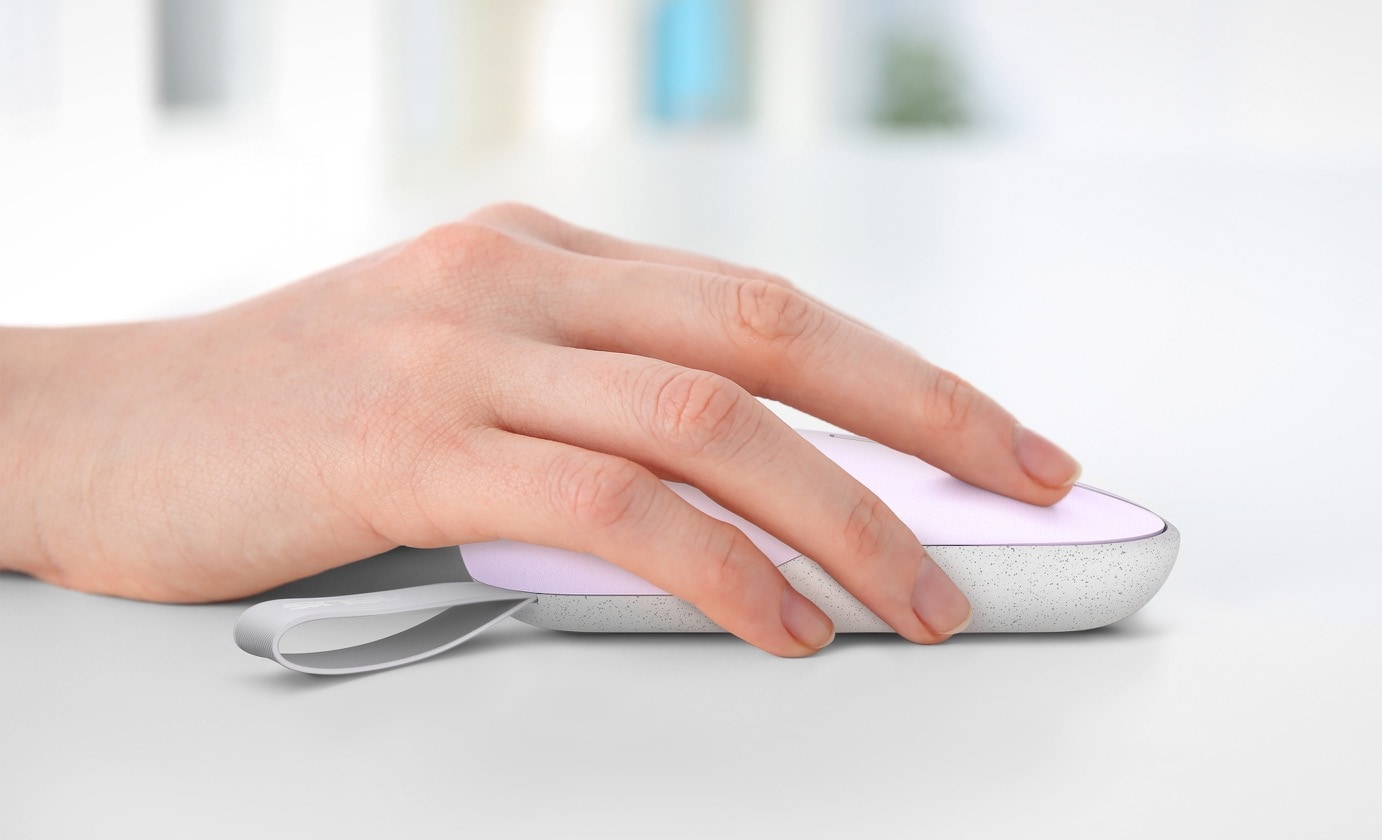 A close-up view of a woman's hand clicking on an ASUS Marshmallow Mouse MD100 with a Lilac Purple finish.
