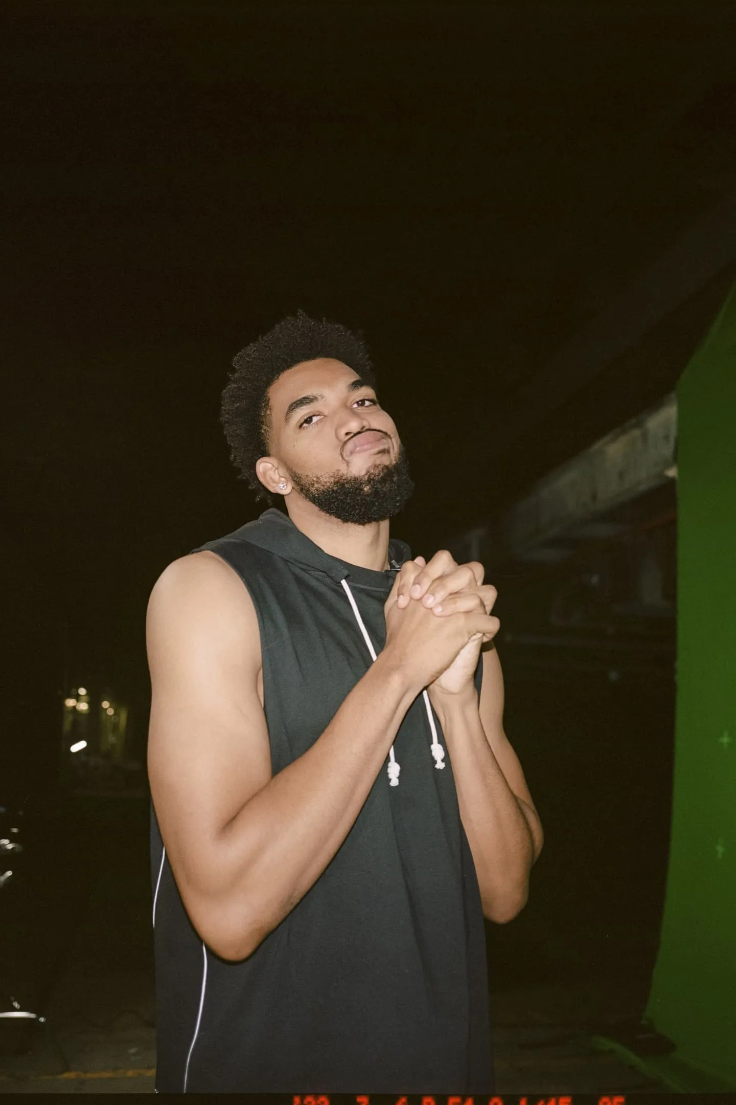 Karl-Anthony Towns posing with his hands clasped in front of his chest.