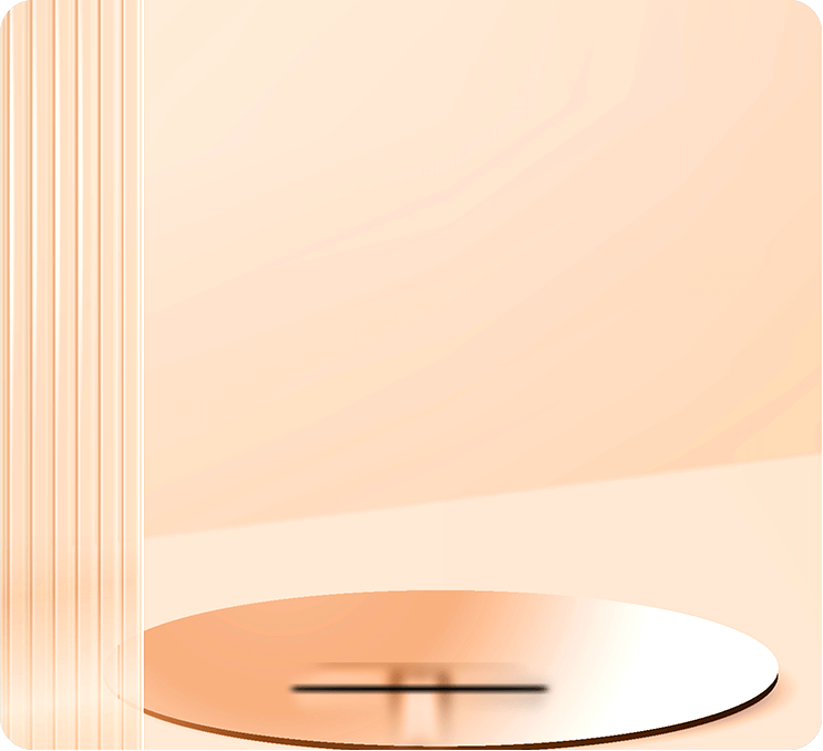 A black monitor with a slim, silver stand is positioned on a peach-colored surface.