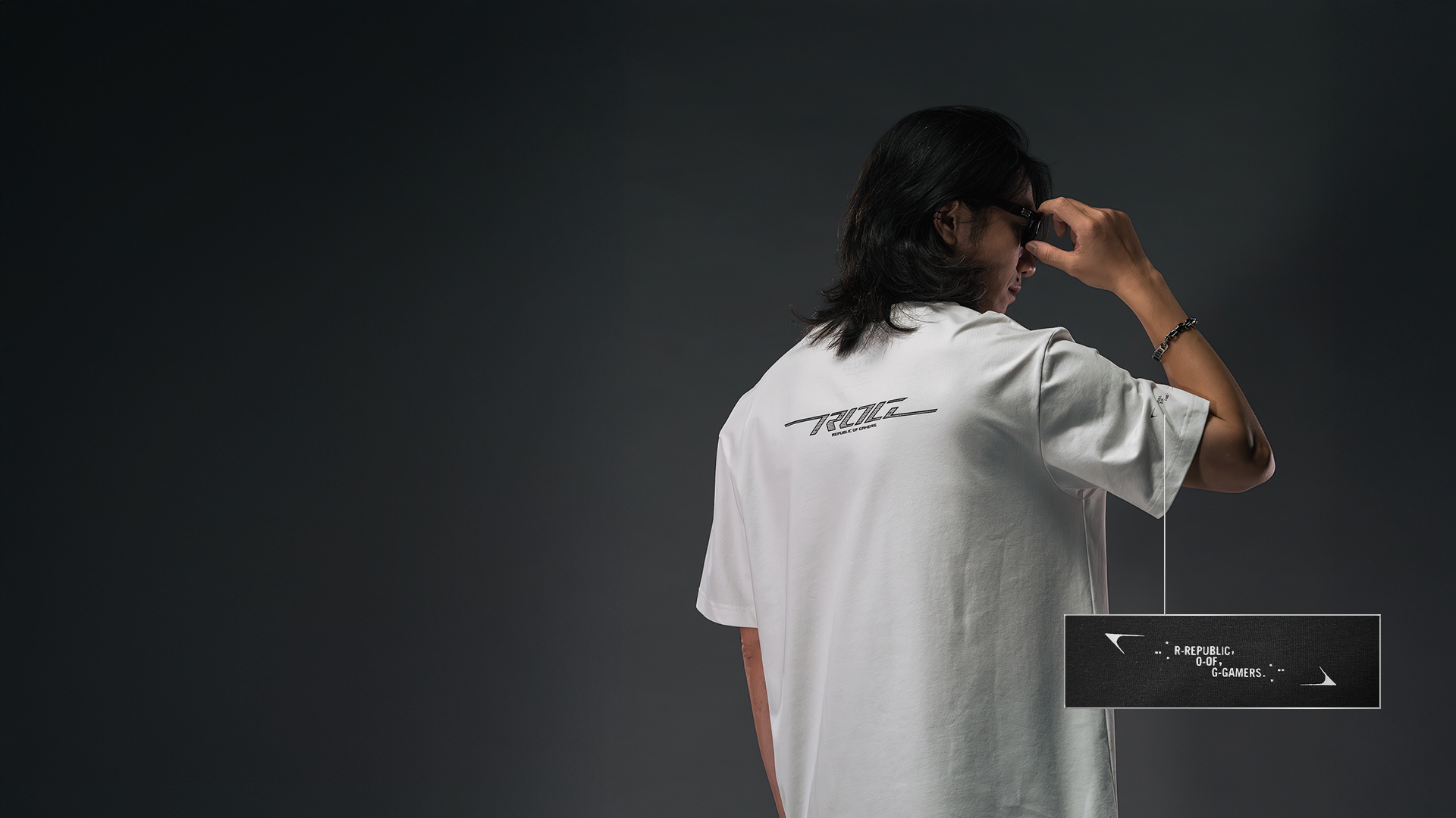 The side view of a men wearing ROG Apex Windbreaker with hands in pockets to indicate the cuff design