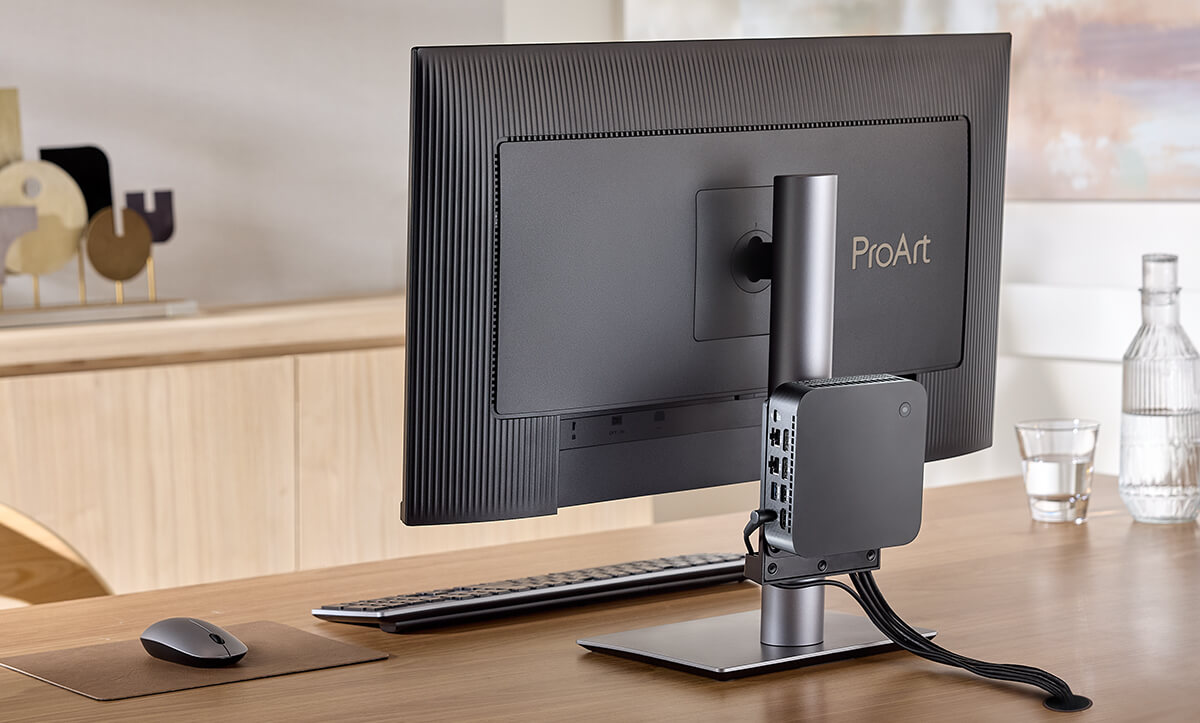 A monitor mounted a NUC/mini PC on the column to shows space-saving.
