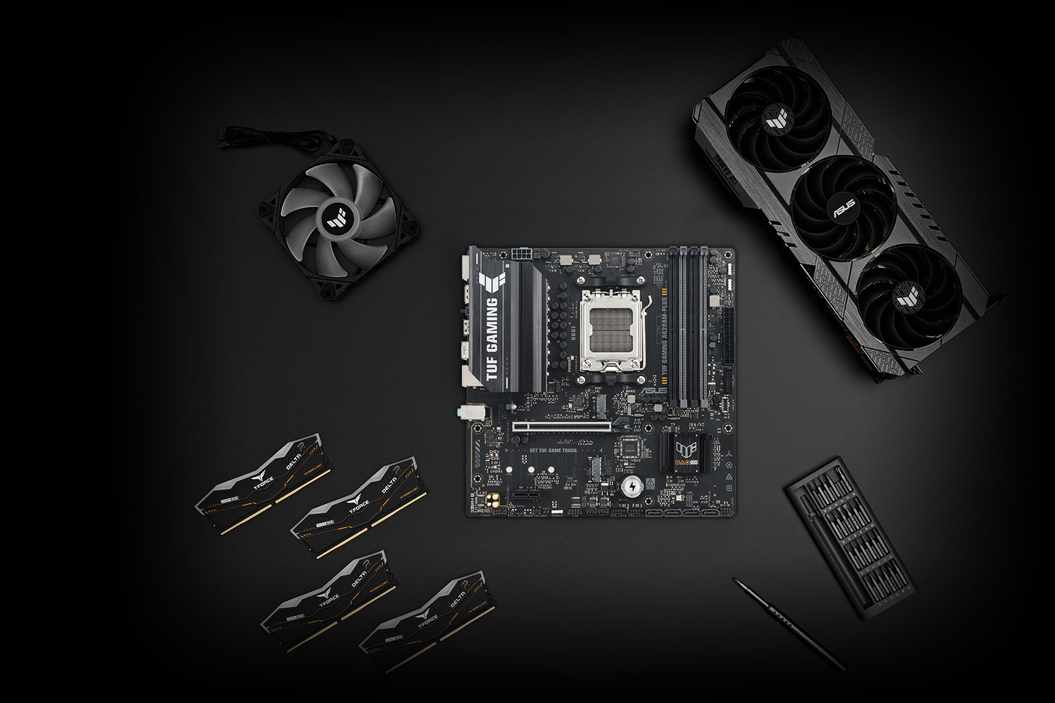 TUF GAMING A620AM-PLUS motherboard placed on a metallic surface with various compatible PC components, including M.2 SSDs and memory modules, arranged neatly around it, representing the TUF Gaming Alliance for guaranteed build compatibility.