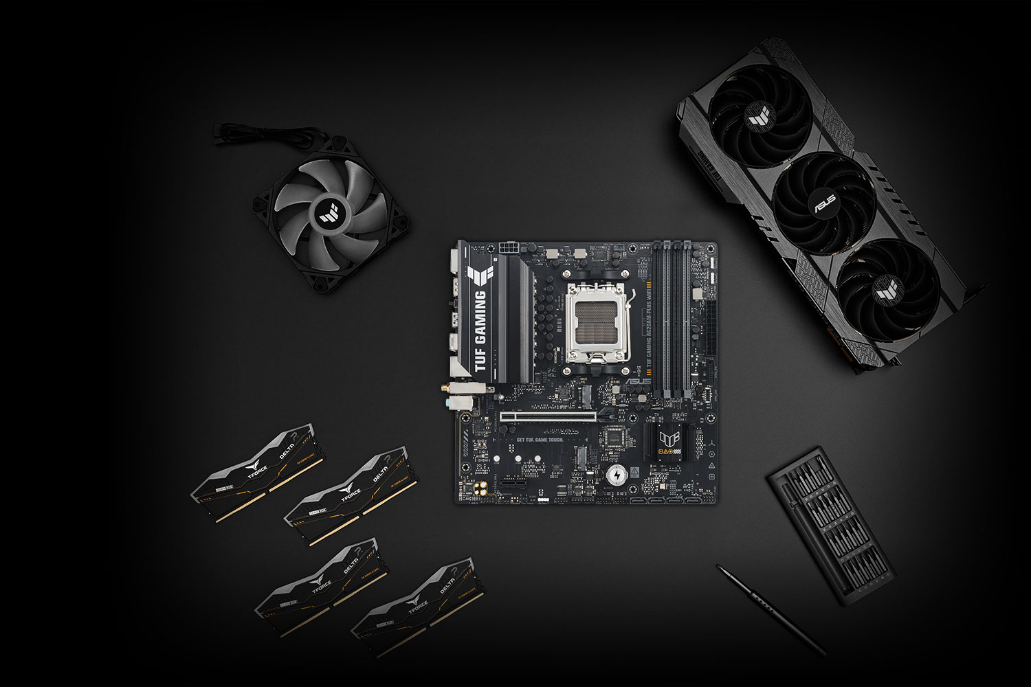 TUF GAMING A620AM-PLUS WIFI motherboard placed on a metallic surface with various compatible PC components, including M.2 SSDs and memory modules, arranged neatly around it, representing the TUF Gaming Alliance for guaranteed build compatibility.