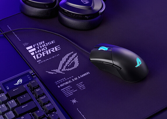 A Gladius III Core mouse placed on a mousepad, next to a Azoth keyboard and a Delta II headset