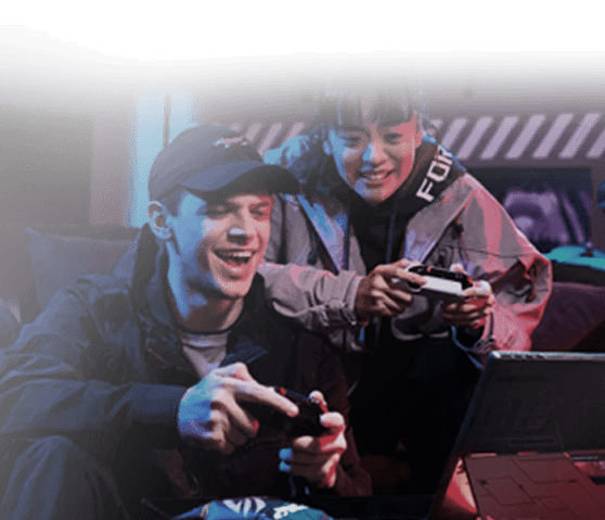 Two gamers playing with controllers in front of an ROG laptop