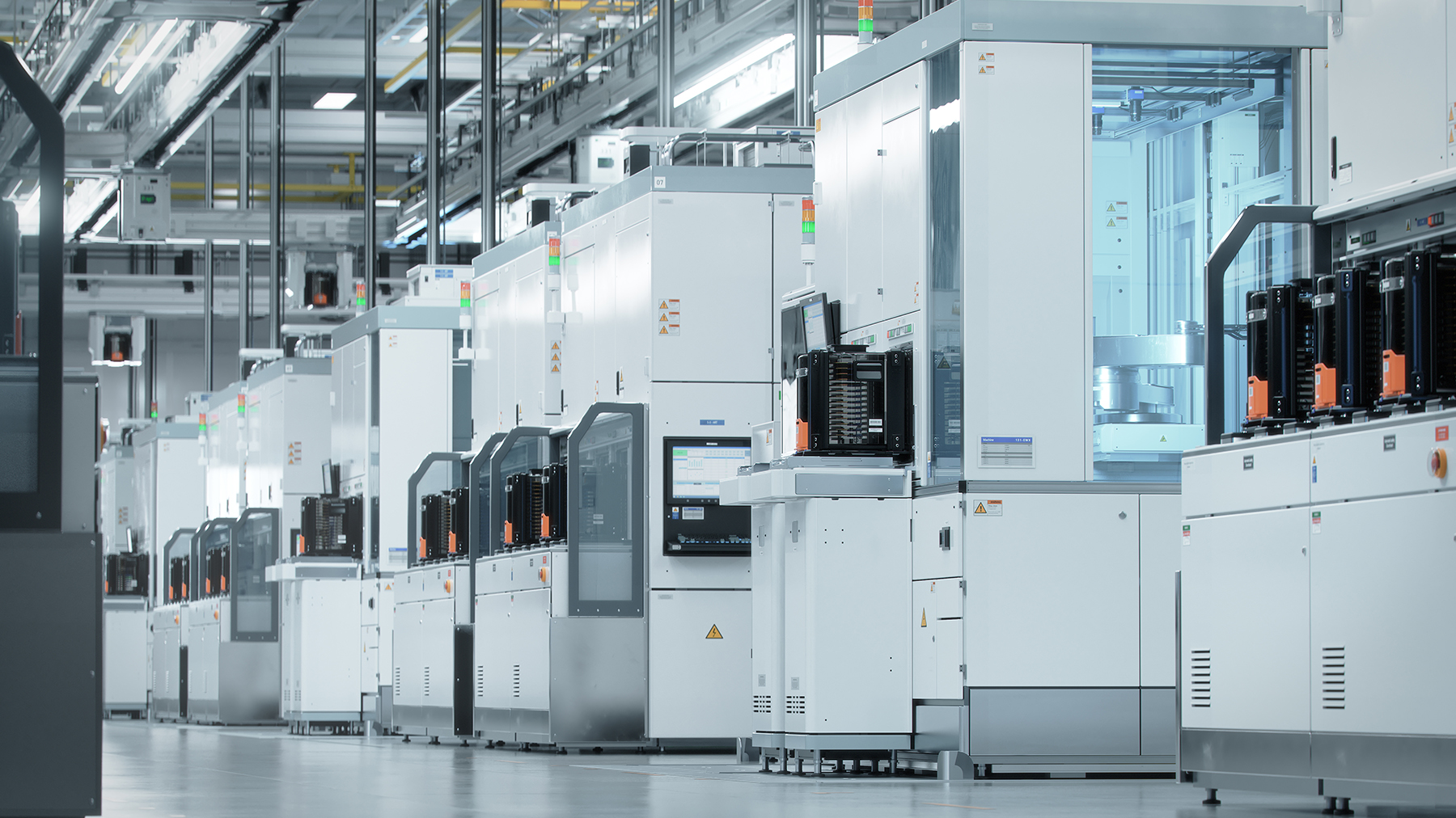 Semiconductor Modern, high-tech semiconductor manufacturing facility with white machinery and equipment lined up in a clean, well-lit environment, conveying precision.