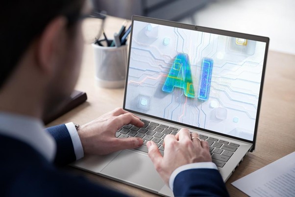 Homem usando notebook com a palavra AI na tela, ilustrando o conceito de o que é IA generativa.