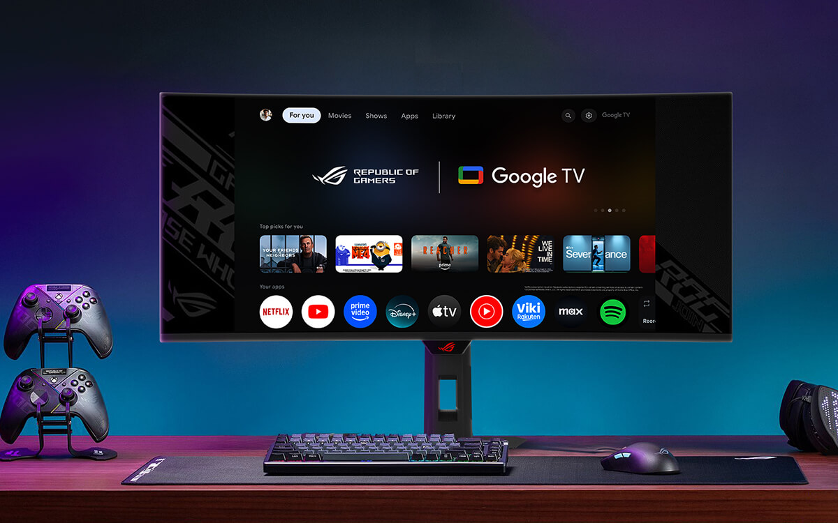 A gaming setup with ROG gaming monitor displaying the Google TV interface
