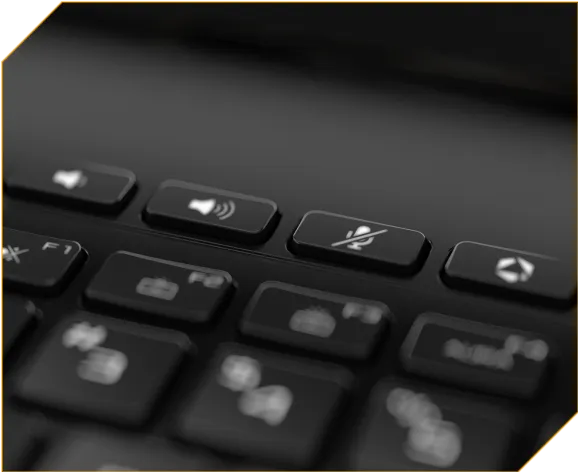 A close-up of dedicated volume, mute, and Armoury Crate keys along the top of a laptop keyboard.