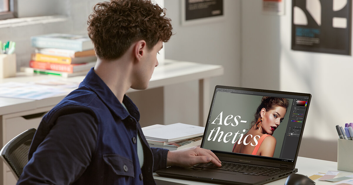 a young content creator editing a photo of a female model on an ASUS Creator laptop