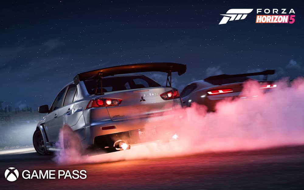 A screenshot of Forza Horizon 5 on Game Pass, with two cars in the dark burning out their tires.