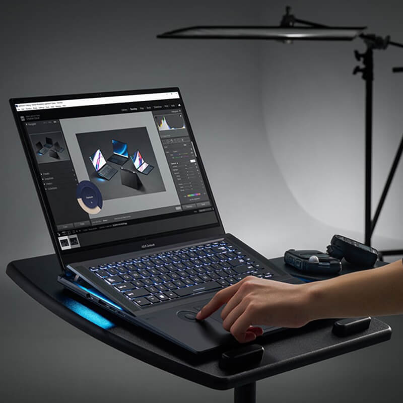 a professional photographer using the Zenbook Pro 16X OLED with ASUS Supernova SoM Design to edit photos on the spot in the studio