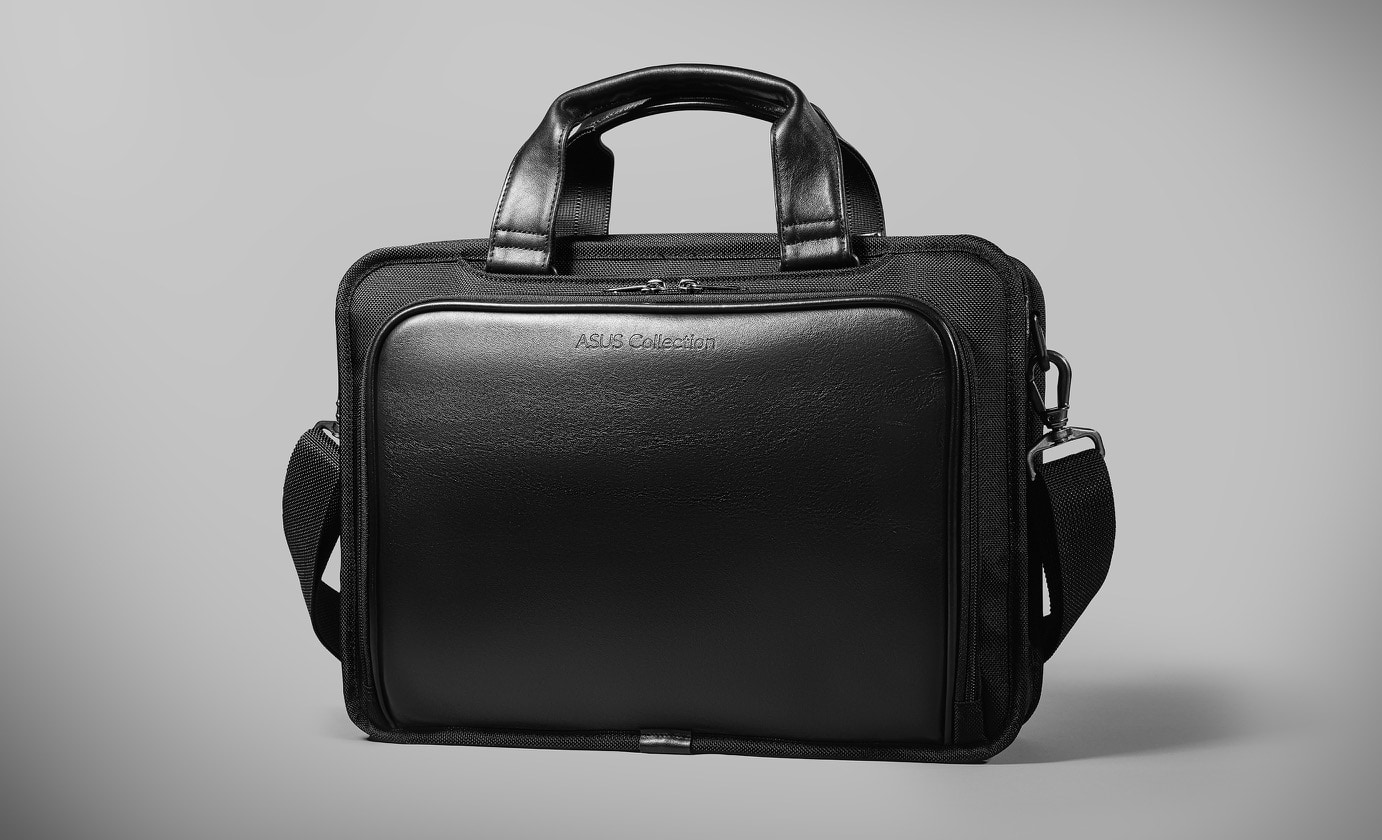 An ASUS Vantage Briefcase 15.6 is shown on the ground, against a monochrome scene.