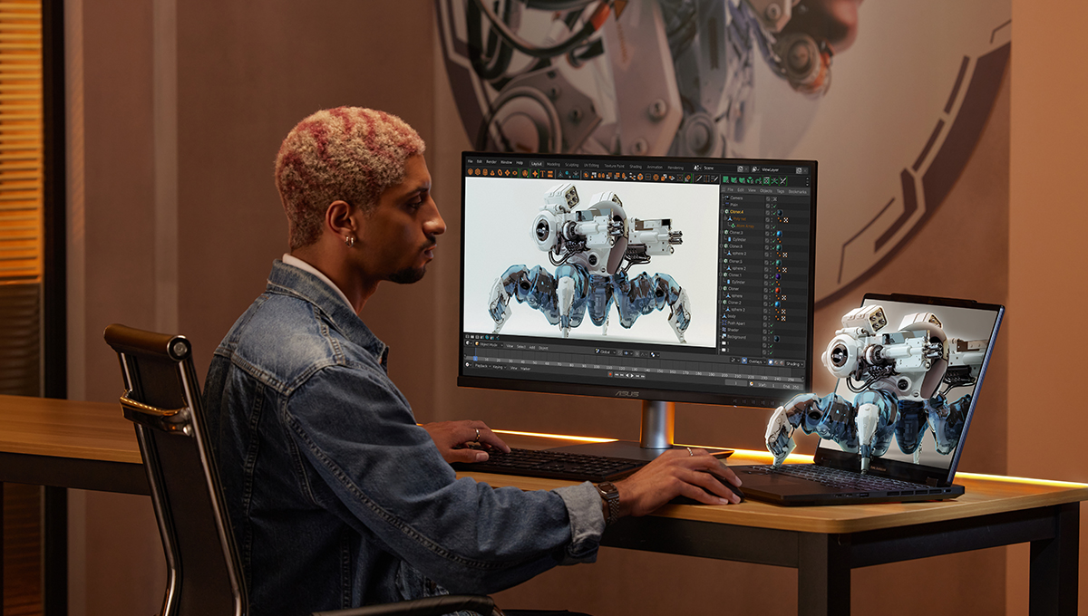 a 3D designer in a studio working on a robot character model using a ProArt monitor and a ProArt Studiobook 16 3D OLED laptop, which is displaying the character render in 3D directly on the laptop screen