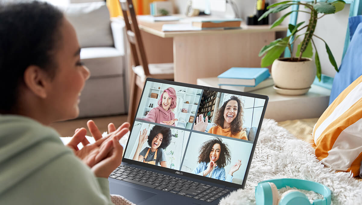 A woman is on a video call with her friends using her ASUS Vivobook.