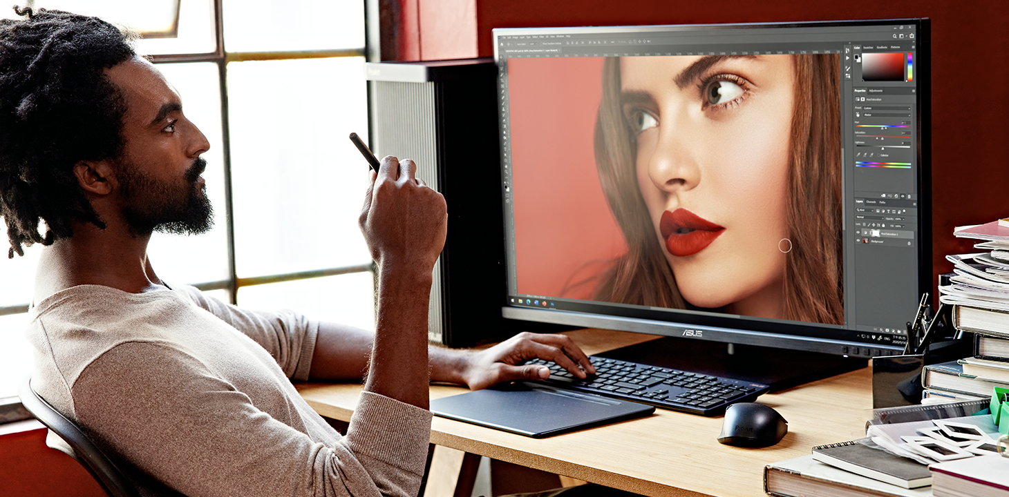 A photographer is retouching a photo by ProArt Station and monitor.