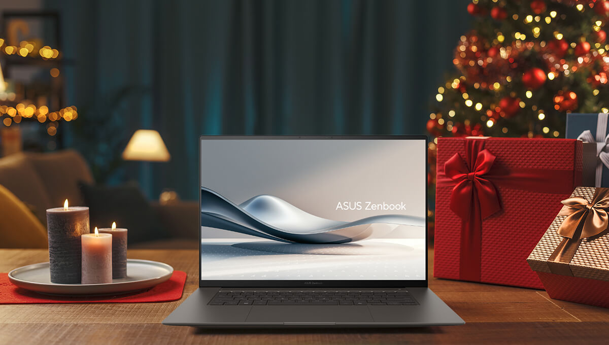 An ASUS Zenbook is placed on a wooden table with holiday decorations around it and in the background.