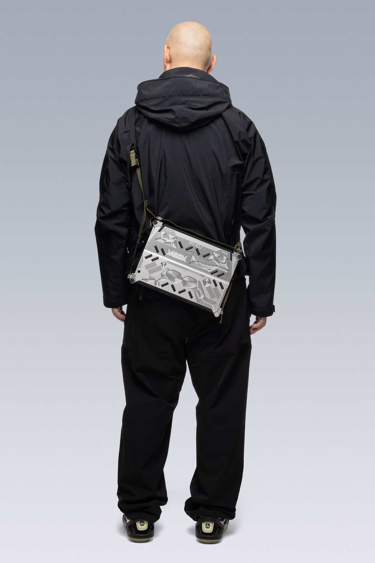 Creative director of ACRONYM Errolson Hugh from behind, wearing the RMT02 in shoulder mode.