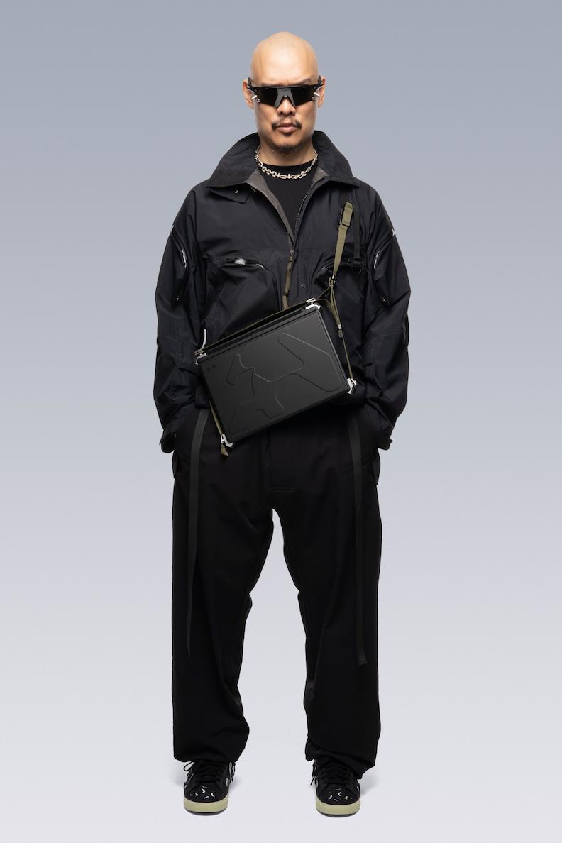 Front side of the creative director of ACRONYM Errolson Hugh, wearing the RMT02 in shoulder mode.