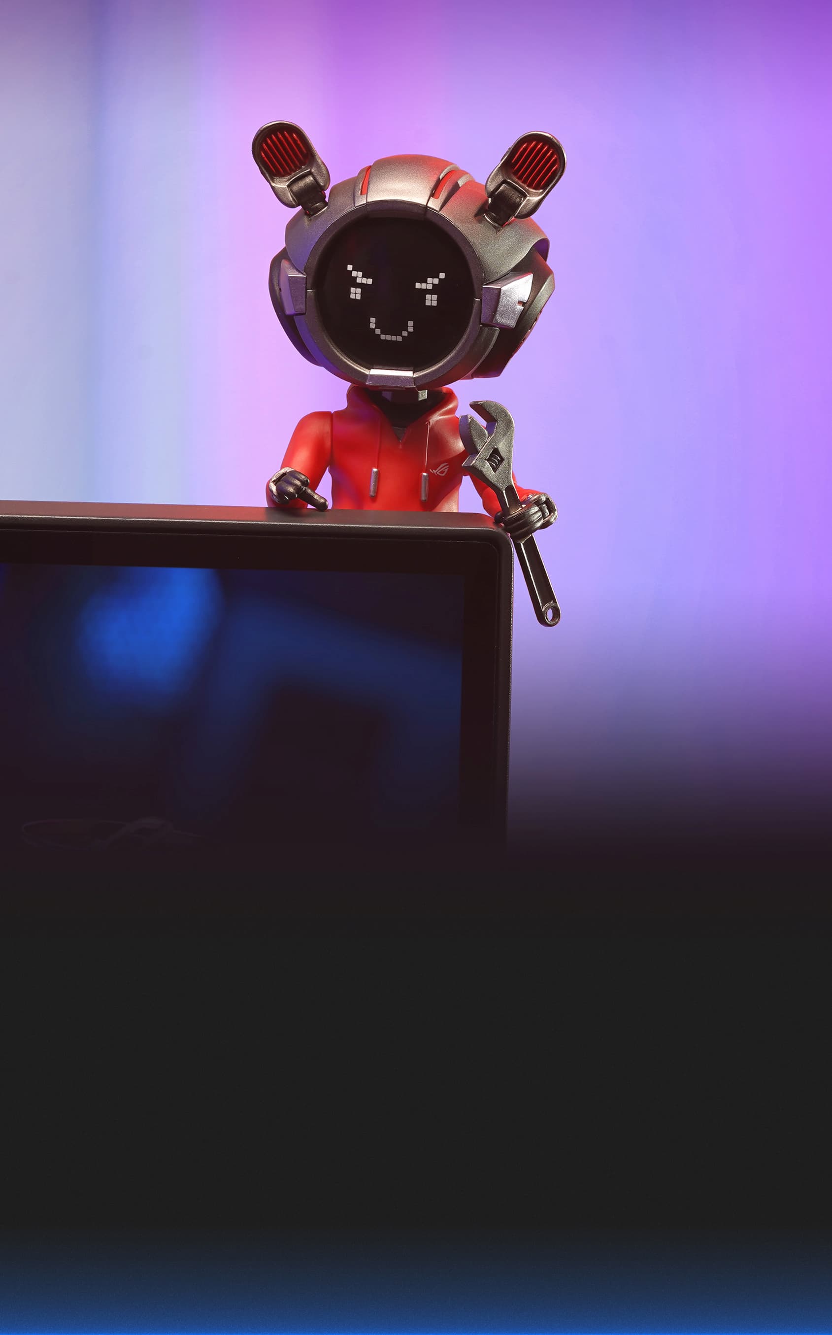 The figure is perched on top of a gaming monitor, holding a wrench, with a playful pixel smile displayed on its face. The scene is paired with the quote “I SEE AND FIX EVERYTHING.” This image highlights OMNI Model OG's fun and tech-savvy personality, making it an ideal gaming desk companion and collectible.