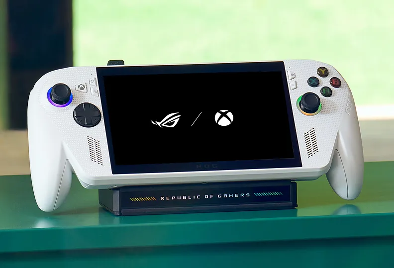 And ROG Xbox Ally mounted atop an ROG Bulwark Dock on a green table.