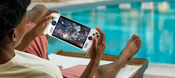 A person near a pool playing the ROG Xbox Ally.