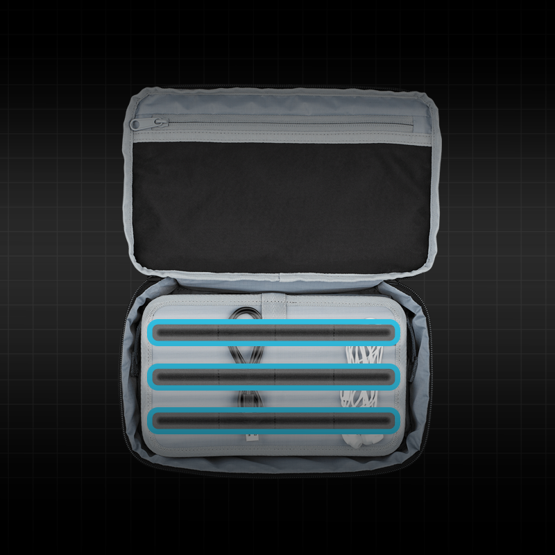 The image shows the ROG Archer Tech Pouch opened, revealing its organized interior compartments. The compartments are holding various accessories and cables, showcasing the pouch's storage capacity and organization features.