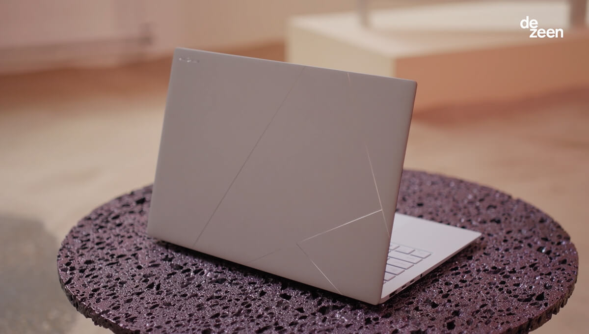 A Zumaia Grey ASUS Zenbook is placed on a surface that has a lava-like texture.