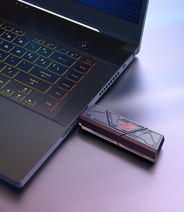 A close-up shot of a laptop with a ROG USB-BE92 plugged into one of its USB Type-A ports.