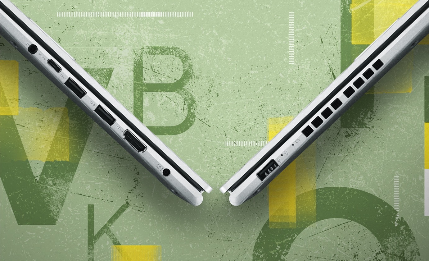 Two Vivobook 15 are closed and shown from left-side and right-side views forming a V-shape, presenting I/O ports from left to right — an audio jack, a USB 3.2 Gen1 Type-C, two USB 3.2 Gen1 Type-A, a HDMI, a DC-in 1.4 and a USB 2.0. 