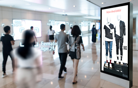 A digital signage with white screen in a busy airport with travelers walking past by