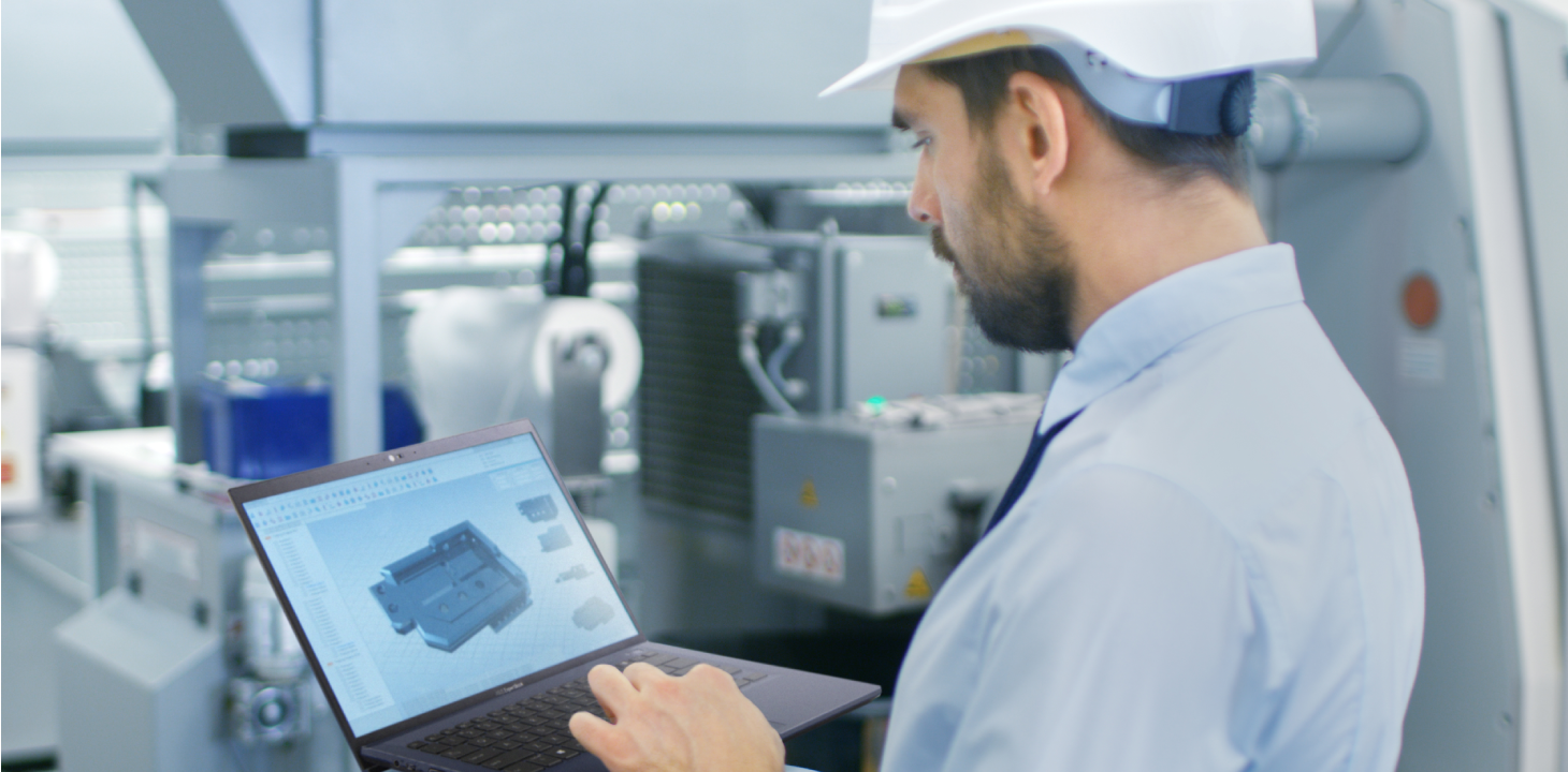 An engineer is looking at a model design shown on ASUS ExpertBook laptop.