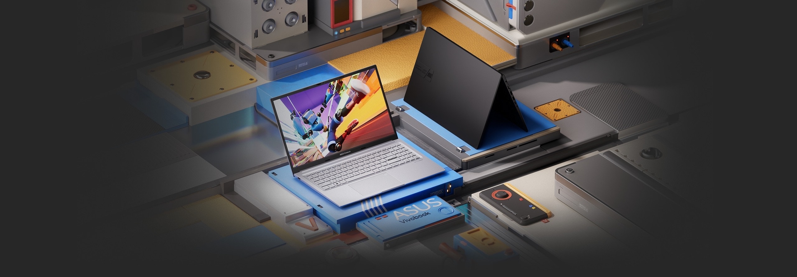 Két nyitott ASUS Vivobook 15X OLED laptop, az ezüstszínű a képernyőt és a billentyűzetet mutatja, a fekete pedig a fedelét.