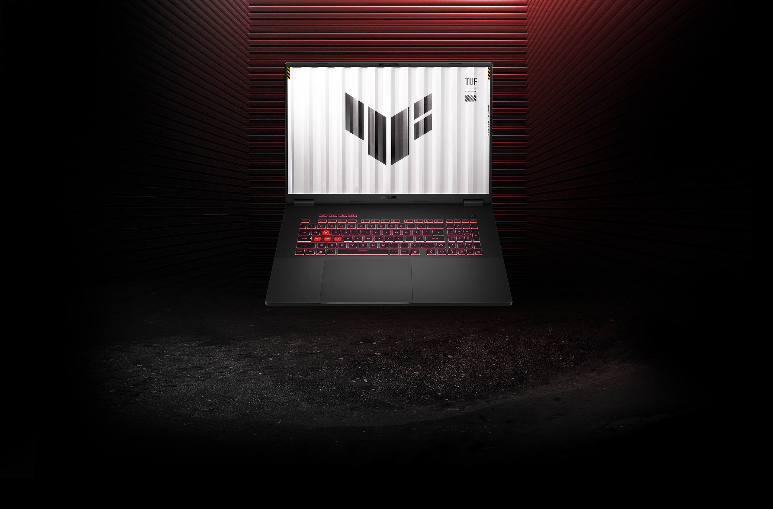 A person wearing a backpack and holding the TUF Gaming A14 in their left hand.
