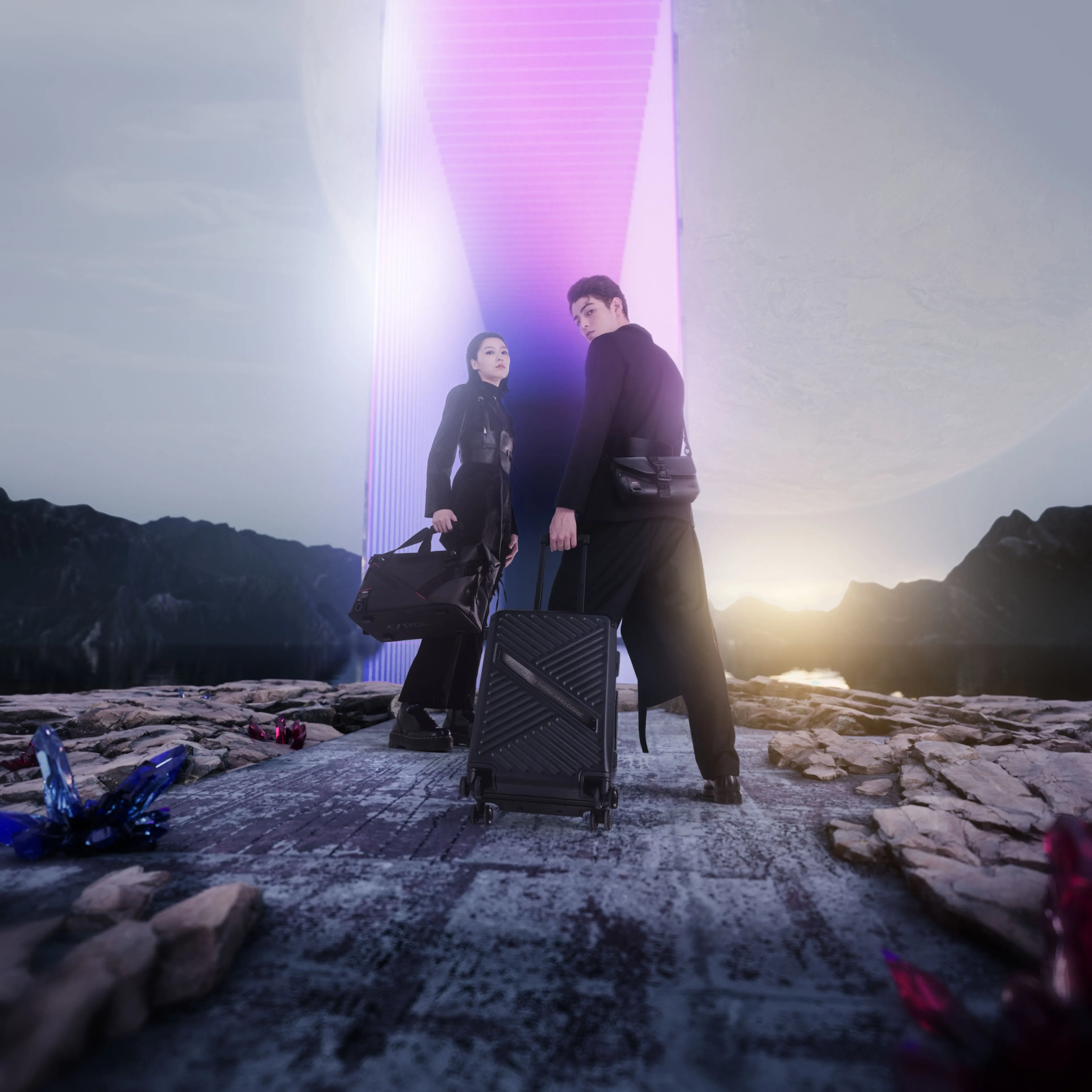 Two people, one wearing the ROG SLASH Sling Bag 2.0 and pulling the Hard Case Luggage, with another holding the Duffle Bag, in a grey landscape with a purple monolith and moon in the background