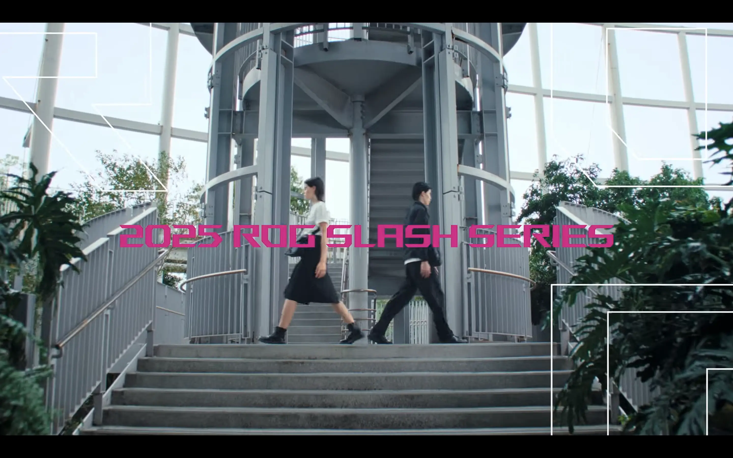 A man and a woman model walking down opposite staircases beside a round gray tower structure, with the text '2025 ROG SLASH SERIES' displayed in the center.