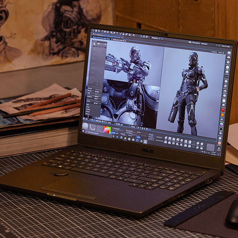 ASUS ProArt Studiobook professional creator laptop with a ProArt Mouse being used for 3D sci-fi character design inside of a designer’s studio
