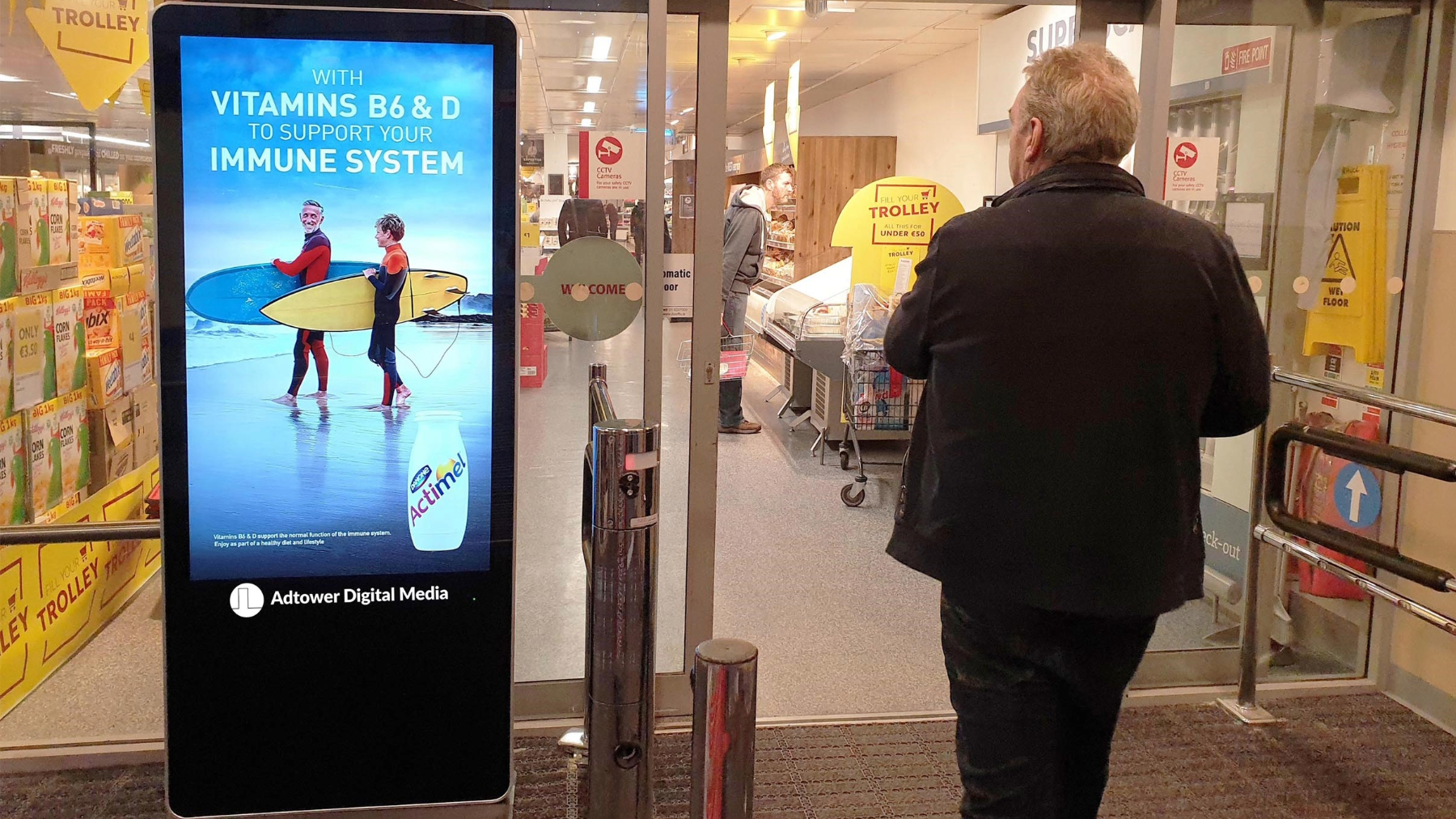 A digital signage display targeted ads to a man passing by 