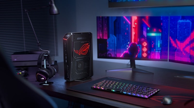 Futuristic gaming setup with dual monitors, neon cityscape, RGB gear, and the best gaming mini PC on a dark desk.