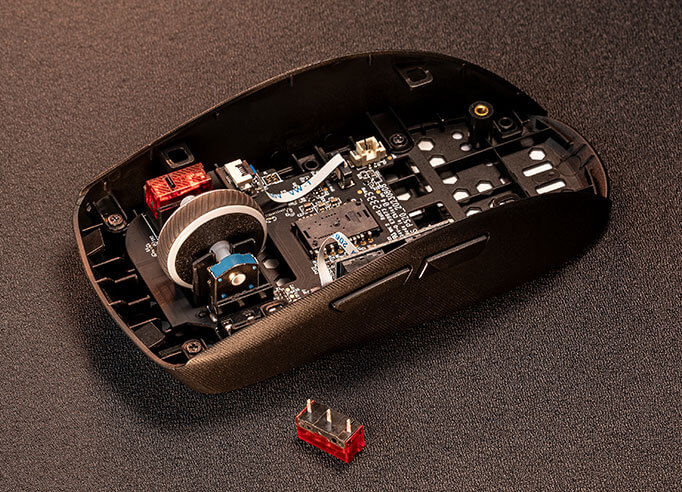 Das Innere einer ROG Strix Impact III Wireless mit einem der ROG Micro Switches, der herausgenommen wurde, um einen besseren Blick auf die Push-Fit Switch-Buchse zu werfen