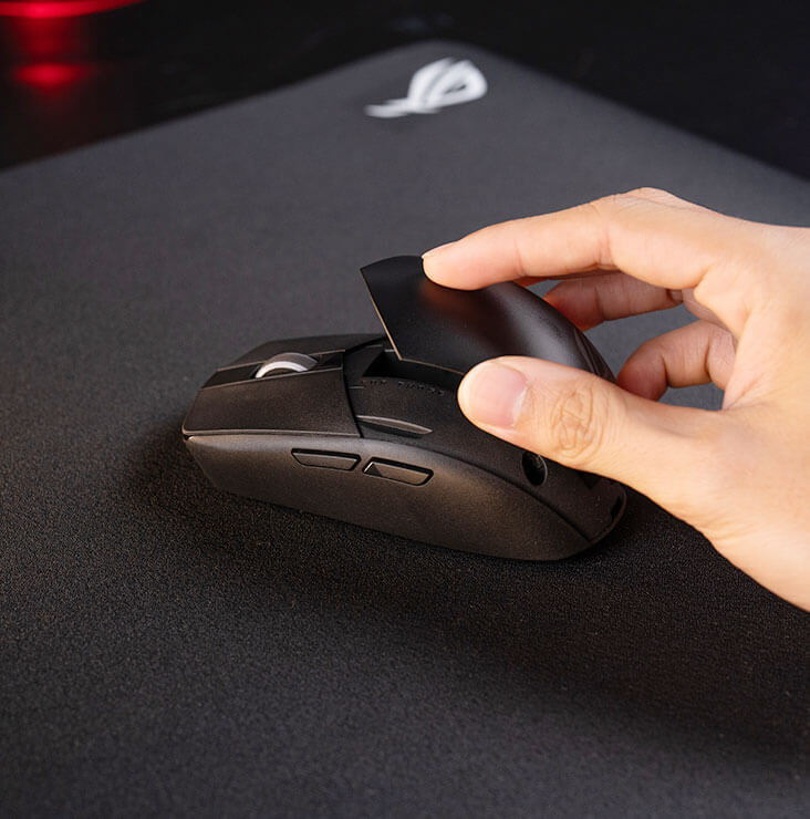 A hand taken off the top cover of the ROG Strix Impact III Wireless