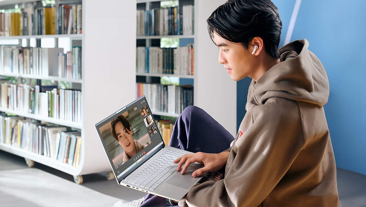 A young man uses ASUS Vivobook S 15 laptop for videoconferencing.