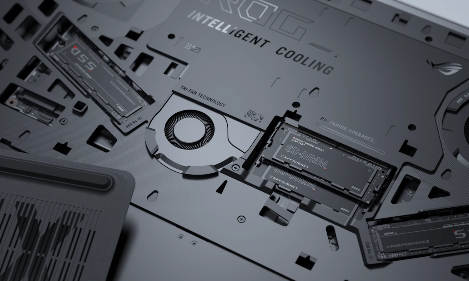 The inside of an ROG Strix laptop with the storage, RAM, and fans visible.